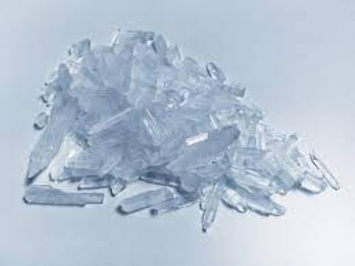 A pile of clear crystalline shards on a light gray background.
